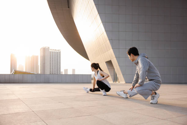 istock Young Asian couples stretch outdoors 1392118668