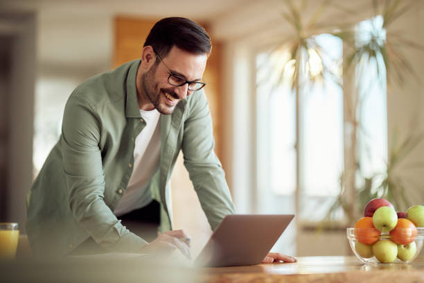 istock Happy businessman working on laptop at home. 1392120833