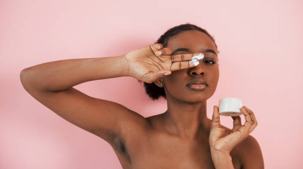 Clean skin conception. Portrait of young african american woman that is against pink background stock photo