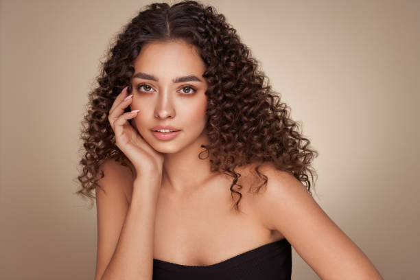 istock Beautiful smiling woman with afro curls 1392121303