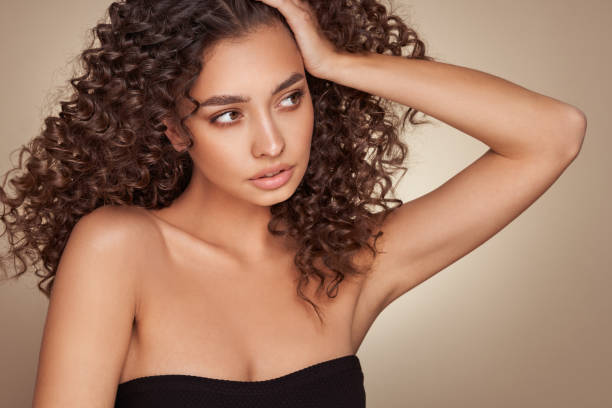 istock Beautiful smiling woman with afro curls 1392121848