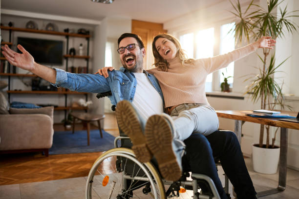 istock Happy disabled man having fun with his girlfriend at home. 1392122364