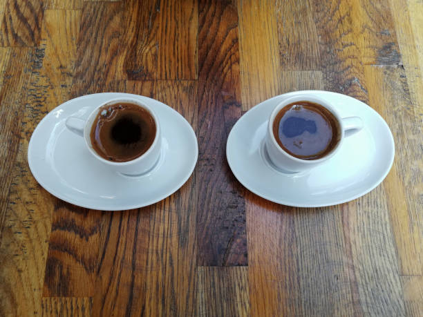 istock Two white cups of coffee on wooden background 1392122436