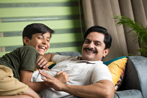 istock Father and son having fun at home 1392122832