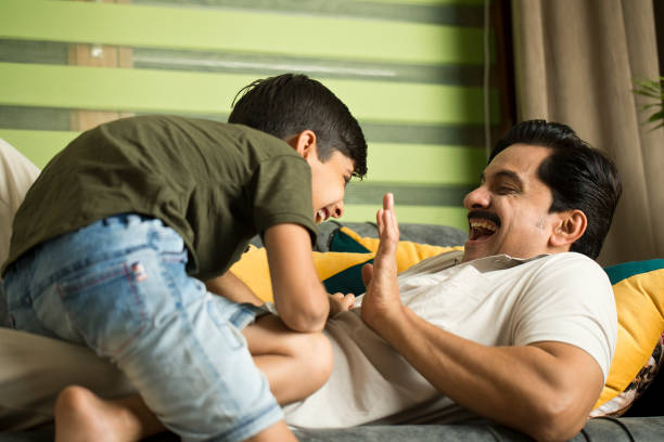 istock Father and son having fun at home 1392122848