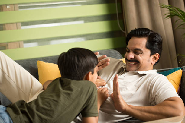 istock Father and son having fun at home 1392122858