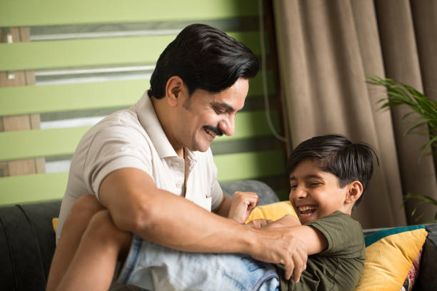 istock Father and son having fun at home 1392122894