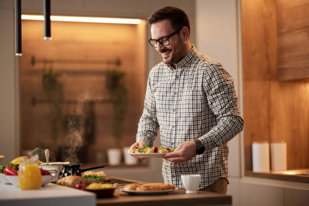 istock Happy man preparing a meal in the kitchen. 1392123621