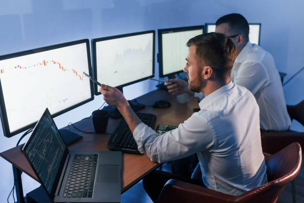 istock Analizing graphs together. Two stock traders working in the office with exchange technology 1392123685