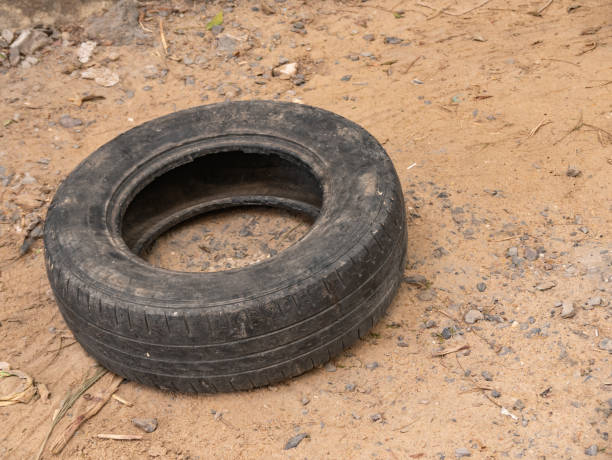 un vieux pneu de voiture gît sur le sol. - tire track egypt track africa photos et images de collection