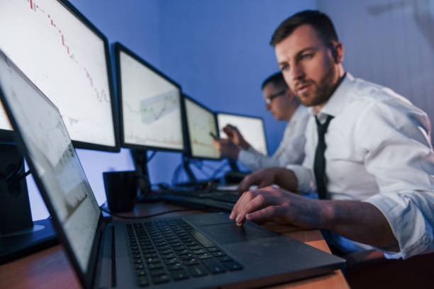 istock Using modern technology to make profit. Two stock traders working in the office with exchange technology 1392124838