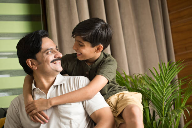istock Father and son having fun at home 1392125162