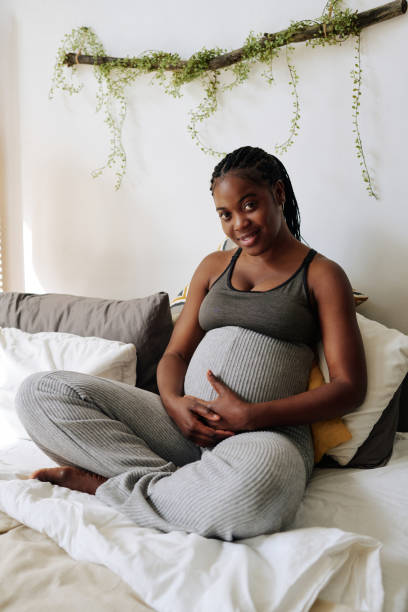 istock Pregnant woman resting on bed 1392125301