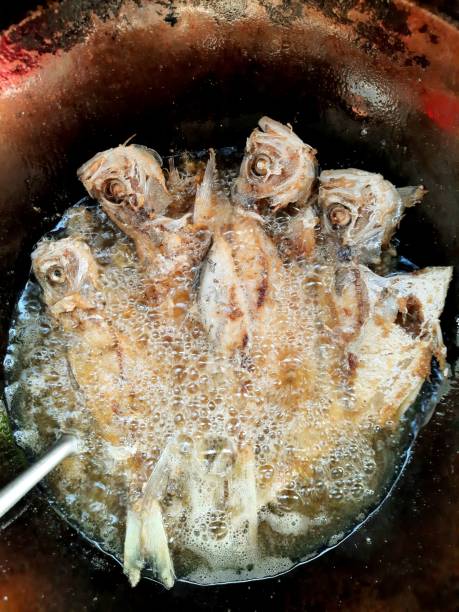 istock Frying Milkfish in cooking pan - food preparation. 1392127171
