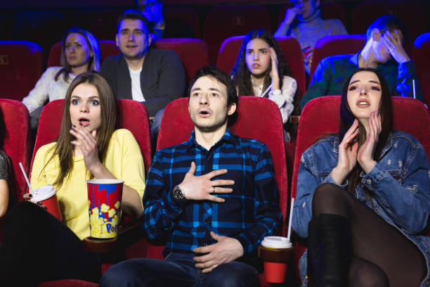 group of people watch a horror movie at the cinema. - audience surprise movie theater shock imagens e fotografias de stock