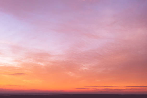 istock Sunset. Abstract pink sky with yellow clouds 1392128176
