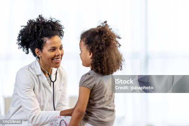 Female Doctor Checks Girls Heartbeat Stock Photo - Download Image Now - Doctor, Child, Pediatrician