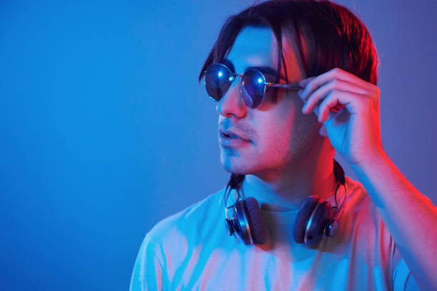 istock Conception of futuristics. Man standing in the studio with neon light 1392128639