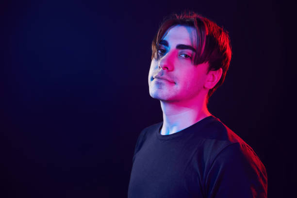 istock Feeling relaxed. Man standing in the studio with neon light 1392128822