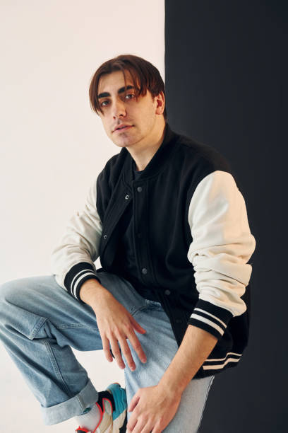 istock Young man is in the studio with white and black walls 1392128886