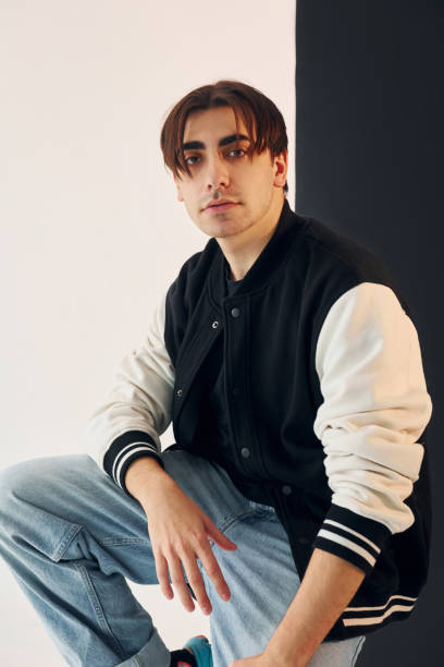 istock Young man is in the studio with white and black walls 1392128895