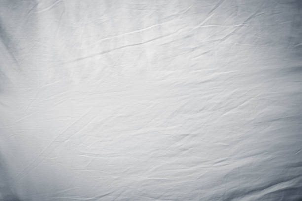 istock white bed linen gradient texture blurred curve style of abstract luxury fabric,Wrinkled bed linen and dark gray shadows,background 1392130601