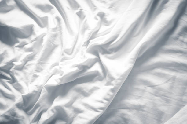 istock white bed linen gradient texture blurred curve style of abstract luxury fabric,Wrinkled bed linen and dark gray shadows,background 1392130625