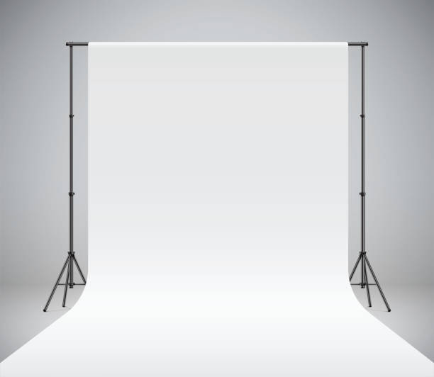 A white photo studio backdrop vector illustration. White photo studio backdrop, realistic vector illustration. Photography polyester background hanging on black stands. Professional photo shooting setup standing on a grey background. photo shoot stock illustrations