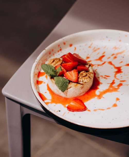 istock Baked Camembert with strawberry, mint and walnut. 1392133625