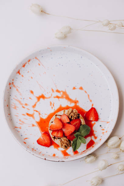 istock Baked Camembert with strawberry, mint and walnut. 1392133634