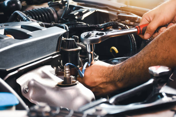 istock The auto mechanic is fixing the engine of the car with a socket wrench 1392133775