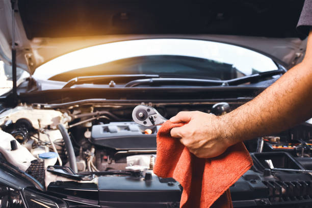 istock Auto mechanic hand holding wrench and red cloth 1392133776