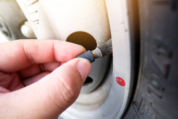 istock The auto mechanic hand puts on the tire valve cap 1392134390