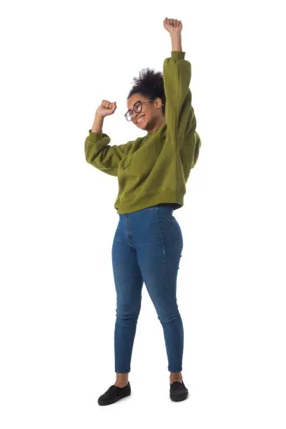 Full length portrait of a cheerful young mixed race woman with arms raised isolated on white background
