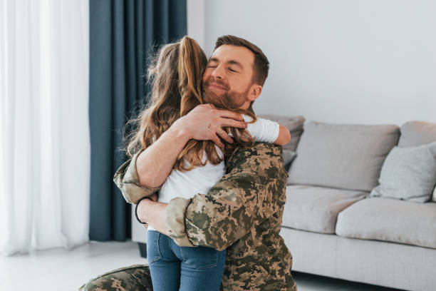 istock Finally at home. Soldier in uniform is with his little daughter 1392134648