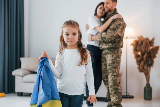 ukrainian's hard times. soldier in uniform is at home with his wife and daughter - domestic life young family family child imagens e fotografias de stock