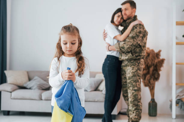 ukrainian's hard times. soldier in uniform is at home with his wife and daughter - domestic life young family family child imagens e fotografias de stock