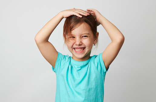 Happy child on white background with copy space. Portrait of a cute smiling girl , close-up