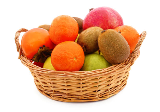 istock Tangerines, pomegranate and kiwi in a basket. 1392136988