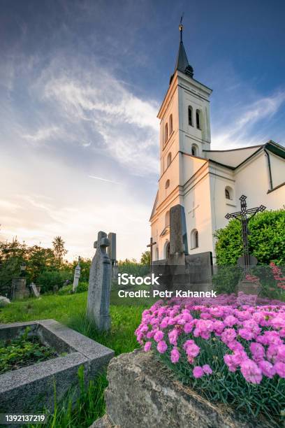 Small Old Christian Church With A Graveyard In Front In The Golden Hour Saint Ignatius Church In Malenovice Czech Republic Stock Photo - Download Image Now