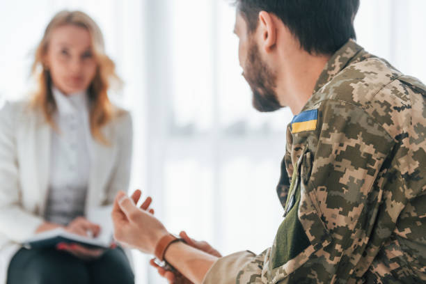 istock Side view. Soldier have therapy session with psychologist indoors 1392138266