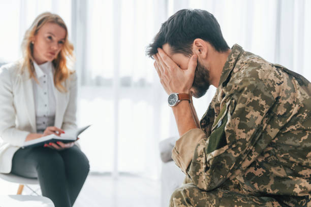 istock Side view. Soldier have therapy session with psychologist indoors 1392138271