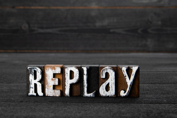 Replay. Text on a dark textured wooden background Replay. Text on a dark textured wooden background. replay stock pictures, royalty-free photos & images