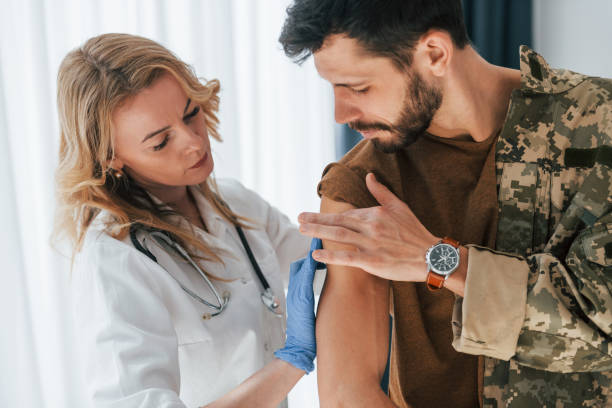 istock Soldier get vaccinated by female doctor indoors 1392138399