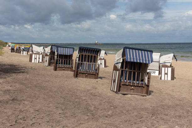 istock Lonely beach wooden wicker chairs on beach cloud sky Baltic Sea, Germany 1392140404