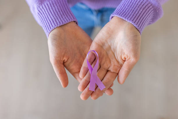 Unrecognizable woman holding in her hands purple ribbon Unrecognizable woman holding in her hands purple ribbon epilepsy stock pictures, royalty-free photos & images