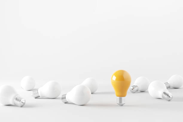 istock Minimal idea of yellow light bulb surrounded with white bulbs on white background. Idea creative Concept. Copy space. 1392141937