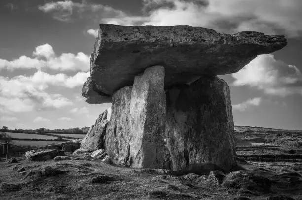 Black and white wide angle study of a dolmen in the Burren, Ireland.