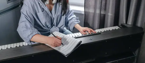 Music.girl plays  piano. Music background, creates music, a soundtrack. Business hobbies, relaxation and psychology. Education and remote work music making. AI-Generated Music