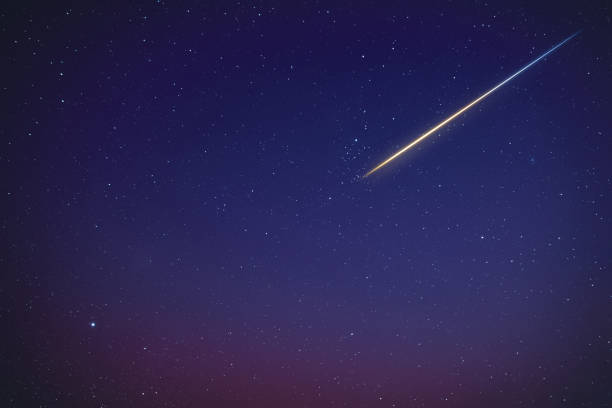istock Stars, meteor trail on evening sky. 1392142529